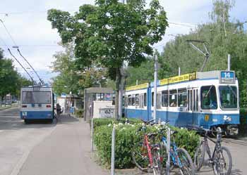 Tram and trolleybus stand either side of a passenger island, providing passengers with easy interchange.