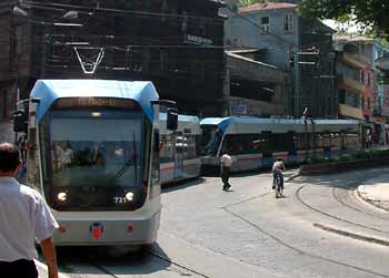 A two-car unit turning a city street corner.