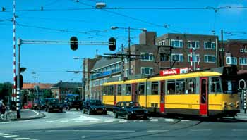 Tram is sharing roadway and bridge with general traffic.