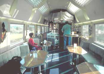 Inside buffet area, with food counter (at far end of carriage) tables and seating.