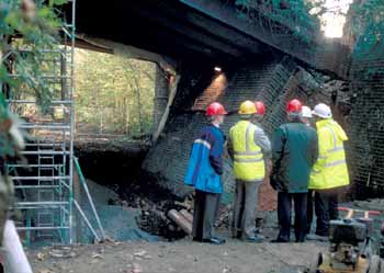 Collapsed bridge abutment with engineers in attendance.