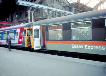 A train comprising of two Class 309 units (in 'Jaffa Cake' and 'Network SouthEast' liveries) at London Liverpool Street Station.