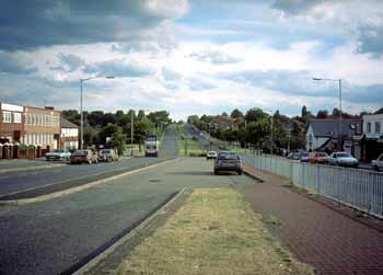 Former guided busway is now a broad swathe of grassland and car parking area.