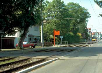 Residential driveway accesses over light rail tracks.