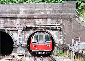 A tube train at a tunnel mouth.
