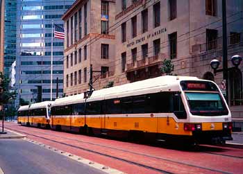 Light rail travelling through city street in Dallas.
