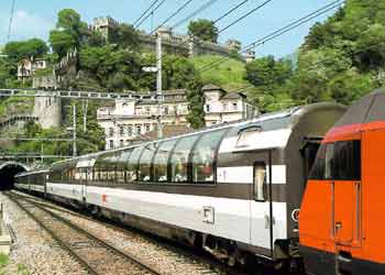 Swiss train partly formed of observation carriages which feature overlarge windows reaching high up the carriage sides.