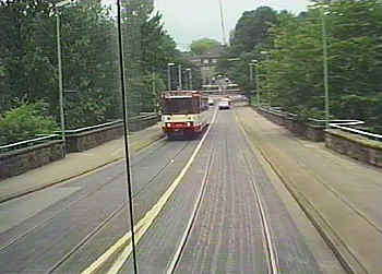 LRV is sharing roadway over bridge with general traffic.